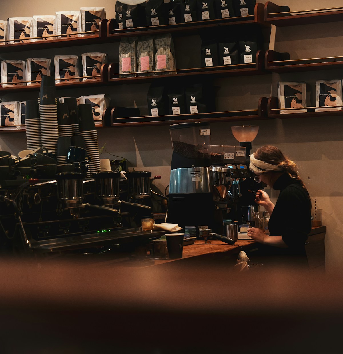 A worker serving customers at Black Fox Coffee in New York City